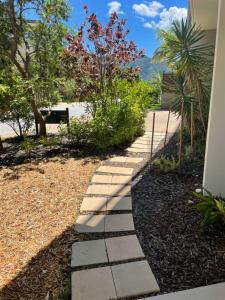 a stone walkway in a yard with trees at Euodia Unit 1102 in Nelly Bay
