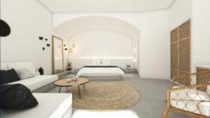 a white living room with a bed and a table at Oia Memories Suites in Oia