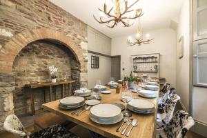 a dining room with a table and a brick wall at Cilrhiw Country House - Princes Gate in Narberth
