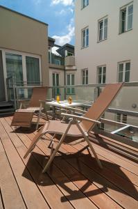 
a patio area with chairs, tables and umbrellas at Safestay Vienna in Vienna
