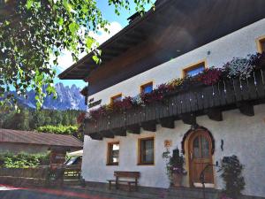 a building with flower boxes on the side of it at Garni Siebnerhof in San Candido