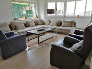 a living room with a couch and a table at Villa Josiane in Oostduinkerke