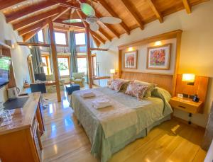 a bedroom with a large bed in a room at Hotel y Cabañas Le Village in San Martín de los Andes +45 photos