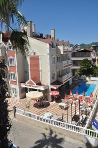a resort with a pool and chairs and umbrellas at BASILS APART HOTEL in Marmaris