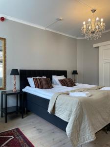 a bedroom with a large bed and a chandelier at Börsen Annex in Visby