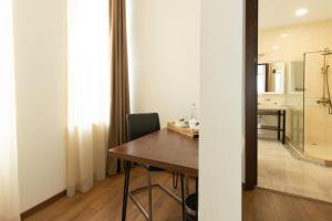 a dining room with a table and a bathroom at Hotel Flower in Tbilisi City