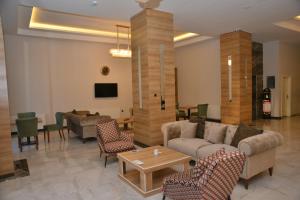 a living room with a couch and chairs and a table at ADIYAMAN PARK HOTEL in Adıyaman