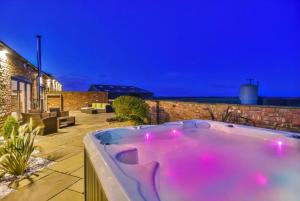 a hot tub with pink lights in a backyard at Captivating 4-Bed House in Lincoln in Lincoln