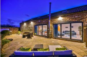 a brick building with a patio at night at Captivating 4-Bed House in Lincoln in Lincoln