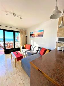 a living room with a couch and a table at Casa Josephine Lanzarote Spectacular sea views FREE WiFi in Puerto del Carmen