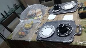 a table with a plate of food and a bag of fruit at LM HOTEL ARAÇATUBA in Araçatuba
