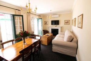 a living room with a table and a couch at De Kothuize 7 in Graaff-Reinet