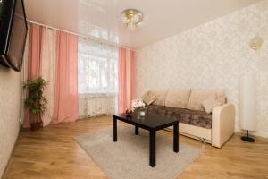 a living room with a couch and a table at Apartment on Osharskaya 15 in Nizhny Novgorod