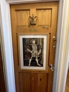 a framed picture of a woman on a wooden door at Olivia House in Porthcawl