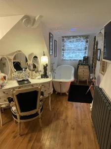 a bathroom with a tub and a sink and a bath tub at Olivia House in Porthcawl