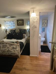a bedroom with a bed and a bathroom with a toilet at Olivia House in Porthcawl
