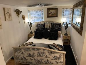 a bedroom with a bed with pillows on it at Olivia House in Porthcawl