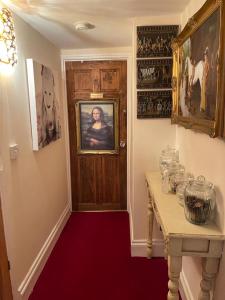 a room with a red carpet and a wooden door at Olivia House in Porthcawl