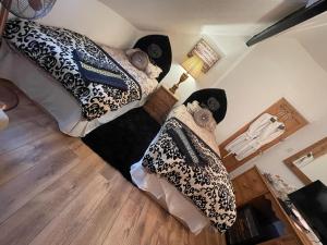 a room with two beds with pillows on them at Olivia House in Porthcawl