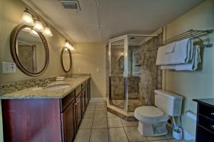 a bathroom with a shower and a sink and a toilet at Dunes of Panama in Panama City Beach