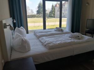Postel nebo postele na pokoji v ubytování Die Remise Kolibri RE-05