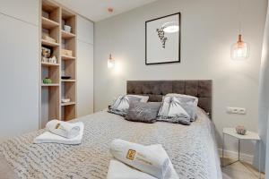 a bedroom with a bed with two pillows on it at 4 Seasons Jelitkowo + Beach in Gdańsk