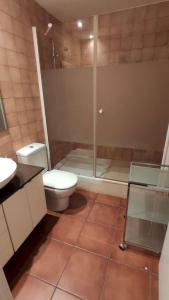 a bathroom with a toilet and a glass shower at MSJ 39 Magnifico Duplex con Vistas al Mar in Calafat +30 photos