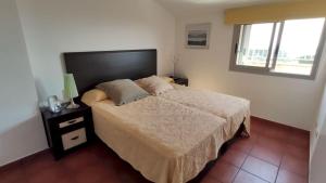a bedroom with a bed and a window at MSJ 39 Magnifico Duplex con Vistas al Mar in Calafat