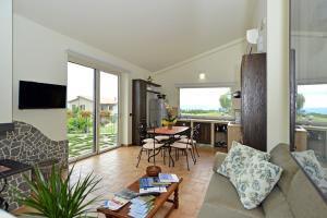 a living room with a couch and a table at Country House Arborea in Bagnoregio