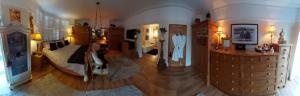 a living room with a large room with wooden floors at Olivia House in Porthcawl