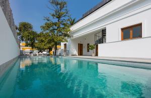 a swimming pool in front of a house at LA VILLA by Villavi in Pondicherry