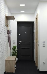 a black door in a hallway with a plant at ART STUDIO 3 in Tashkent