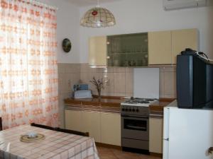 kuchnia z kuchenką, lodówką i stołem w obiekcie Apartment in Banjol with sea view, terrace, air conditioning, Wi-Fi (3803-1) w mieście Banjol