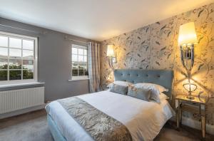 a bedroom with a large bed and a large window at Georgian House Hotel in Whitehaven
