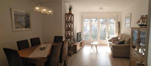 a living room with a dining room table and a couch at BLANES APARTAMENTO in Blanes