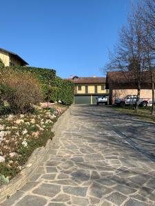 a stone driveway in front of a house at conGusto Apartments in Cherasco