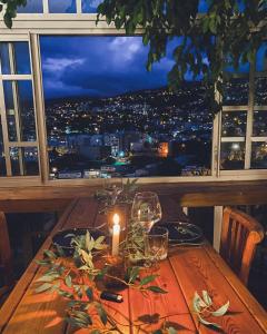 a table with a candle and a view of a city at Loft mezzanine verrière avec vue in Saint-Denis