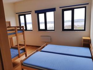a bedroom with two bunk beds and windows at Lacs de l'eau d'heure Amiral 24 in Erpion