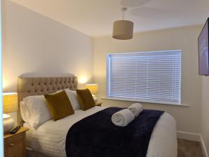 a bedroom with a large bed and a window at No 3 king street apartment and snug in Seahouses