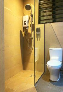 a bathroom with a toilet and a shower stall at Amadel Residence 爱媄德民宿 16 in Melaka