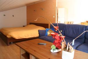 a living room with a couch and a table at Albizia in Saint-Julien-des-Landes