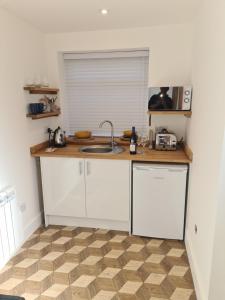 a kitchen with a sink and a counter top at No 3 king street apartment and snug in Seahouses +3 photos