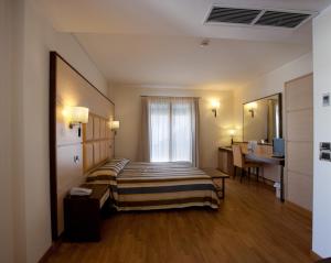 a hotel room with a bed and a desk at Virgilio Grand Hotel in Sperlonga