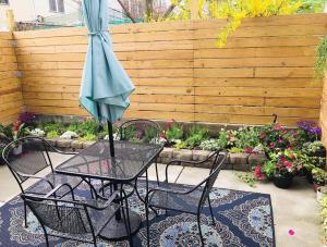 a table and chairs with an umbrella on a patio at Artsy Hidden Gem ll -Free Parking -- in Philadelphia