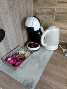 eine Kaffeemaschine, ein Tablett mit Essen und eine Tasse in der Unterkunft Apartment Tony in Interlaken