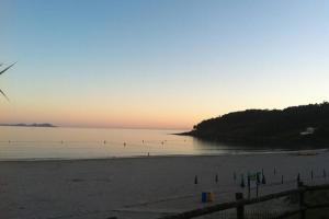 - Vistas a la playa al atardecer con el océano en Chalet Arena de Canelas en 1ª línea de Playa, Sanxenxo, en Portonovo