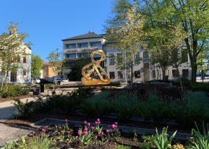 a sculpture in a park in front of a building at Nybro Stora Hotellet in Nybro