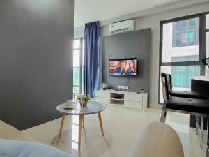 a living room with a table and a tv at Liberty Arc Ampang by BeeStay Management in Ampang