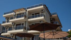 a tall building with two umbrellas in front of it at Solinaria Boutique Hotel in Sozopol