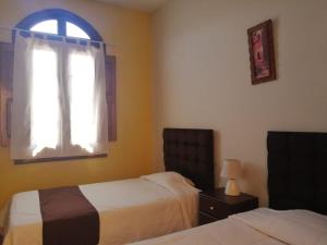 Een bed of bedden in een kamer bij El MONARCA AREQUIPA